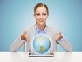 Business woman with tablet pc and globe hologram