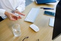 Business woman taking pill from blister pack. Royalty Free Stock Photo