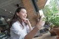 Business woman taking selfie on the Smart phone in coffee break time at her work place.young business online marketing concept Royalty Free Stock Photo