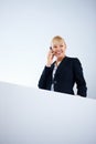 Business woman talking on cell phone. Portrait of business woman talking on cell phone by wall. Royalty Free Stock Photo