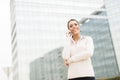 Business woman talking on mobile phone in front of office Royalty Free Stock Photo