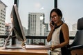 Business Woman talking with mobile phone on her desk in Modern office building Royalty Free Stock Photo