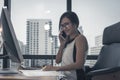 Business Woman talking with mobile phone on her desk in Modern office building Royalty Free Stock Photo