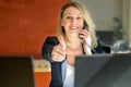 Business woman talking over phone showing thumbs up sign Royalty Free Stock Photo