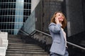 Business woman talking on the phone in the background of an office building Royalty Free Stock Photo