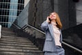 Business woman talking on the phone in the background of an office building Royalty Free Stock Photo