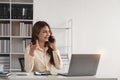 Business woman talking on a phone call in office. Happy female professional calling her associates on a mobile phone Royalty Free Stock Photo