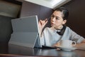 Business woman thinking new idea work plan, hold pen on hand. sitting using tablet Laptop Computer