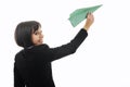 Business woman throwing paper airplane