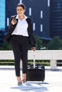 Business woman, travel with luggage and phone for communication with work, internet or web search. Corporate employee