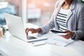 Business woman typing on laptop, reading from notebook and planning a strategy in an office at work. Corporate employee Royalty Free Stock Photo