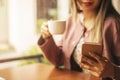 Business woman typing text message on smart phone in a cafe, Close up of female hands holding cell telephone with screen Royalty Free Stock Photo