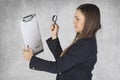 Business woman uses a magnifying glass to read the agreement Royalty Free Stock Photo