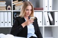 Business woman uses a smartphone in the office Royalty Free Stock Photo
