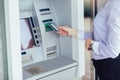 Person using credit card to withdrawing money from atm machine Royalty Free Stock Photo