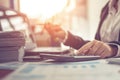 Business woman using calculator and writing make note with calculate. Woman working at office with laptop and documents on his Royalty Free Stock Photo