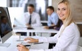 Business woman using computer at workplace in modern office. Secretary or female lawyer smiling and looks happy. Working Royalty Free Stock Photo