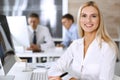 Business woman using computer at workplace in modern office. Secretary or female lawyer smiling and looks happy. Working Royalty Free Stock Photo