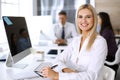 Business woman using computer at workplace in modern office. Secretary or female lawyer smiling and looks happy. Working Royalty Free Stock Photo