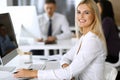 Business woman using computer at workplace in modern office. Secretary or female lawyer smiling and looks happy. Working Royalty Free Stock Photo