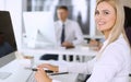 Business woman using computer at workplace in modern office. Secretary or female lawyer smiling and looks happy. Working Royalty Free Stock Photo