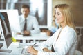 Business woman using computer at workplace in modern office. Secretary or female lawyer smiling and looks happy. Working Royalty Free Stock Photo