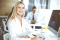 Business woman using computer at workplace in modern office. Secretary or female lawyer smiling and looks happy. Working Royalty Free Stock Photo