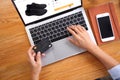Business woman using credit card for buy black running shoes on ecommerce website via laptop with smartphone and note book Royalty Free Stock Photo