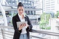 Business woman using digital tablet computer outside office. happy young beautiful girl working on social media outdoor over Royalty Free Stock Photo