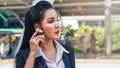Business woman using earphone outdoor in city Royalty Free Stock Photo