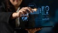 Business woman using futuristic technology to analyze data with touchscreen interface and graphs, digital information Royalty Free Stock Photo