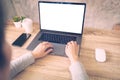 Business woman using laptop computer do online activity on wood table at home office