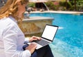 Business woman using laptop computer on vacation in resort by the pool Royalty Free Stock Photo