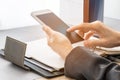 Business woman using mobile phone with blank planner