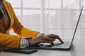 Business woman using mobile phone during working on laptop computer, surfing the internet, searching business data at modern Royalty Free Stock Photo