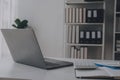 Business woman using mobile phone during working on laptop computer, surfing the internet, searching business data at modern Royalty Free Stock Photo