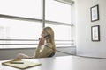 Business woman using phone sitting at office desk side view Royalty Free Stock Photo