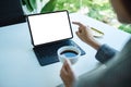 A business woman using and pointing finger at tablet pc with blank desktop white screen as a computer pc in the Royalty Free Stock Photo