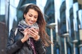 Business woman using smart phone on a background office building Royalty Free Stock Photo