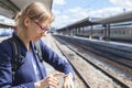 Business woman using smart watch at train station Royalty Free Stock Photo