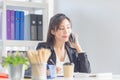 Business woman using smartphone in office. Excited pretty girl using mobile phones in office, woman working in the office Royalty Free Stock Photo