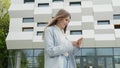 Business woman using smartphone texting female executive checking emails browsing messages on mobile phone. Business Royalty Free Stock Photo