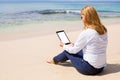Business woman using tablet computer on the beach Royalty Free Stock Photo