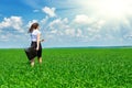 Business woman walk on green grass field outdoor and relax under sun. Beautiful young girl dressed in suit resting, spring landsca Royalty Free Stock Photo