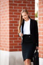 Business woman walking on stairs outdor carying business folder and hand bag Royalty Free Stock Photo