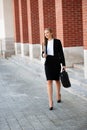 Business woman walking on stairs outdor carying business folder and hand bag Royalty Free Stock Photo