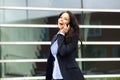 Business woman walking and talking on cell phone Royalty Free Stock Photo