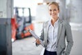 Business woman, warehouse and clipboard in portrait, production and logistics at shipping company. Manager, happy and Royalty Free Stock Photo