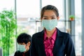 Business woman was sick from flu in the office and the male enployee offer the protecitve face mask sfety fro COVID-19 virus Royalty Free Stock Photo