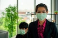 Business woman was sick from flu in the office and the male enployee offer the protecitve face mask sfety fro COVID-19 virus Royalty Free Stock Photo